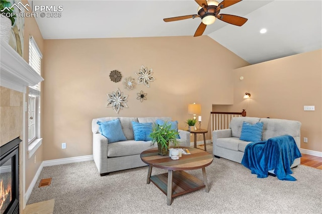 living room with lofted ceiling and a fireplace