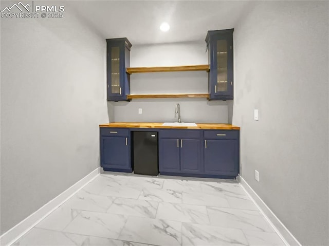 kitchen featuring sink and wooden counters