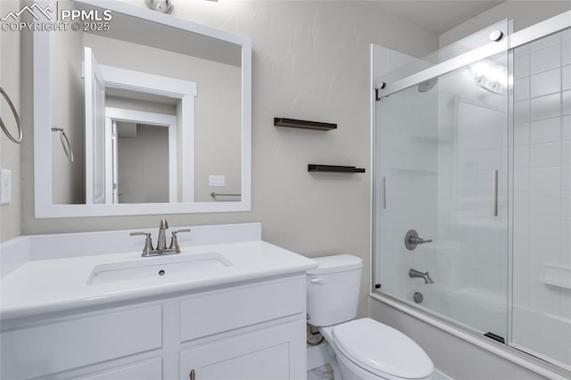 full bathroom with vanity, toilet, and combined bath / shower with glass door