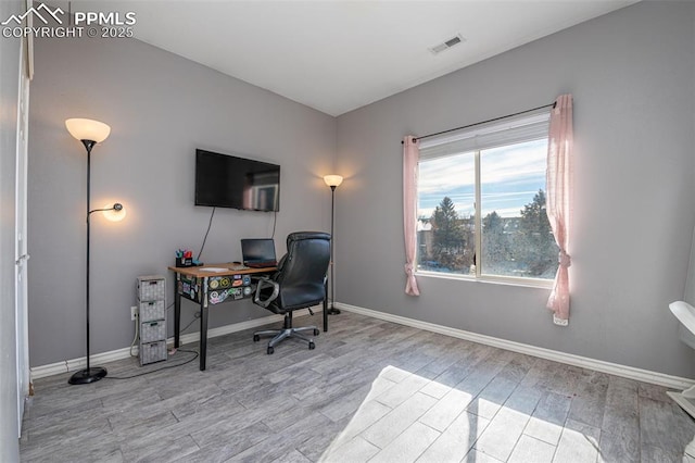 home office with light wood-type flooring