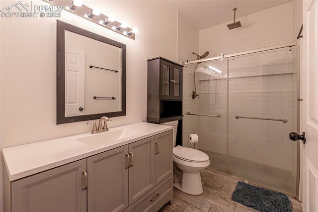 bathroom with vanity, toilet, and walk in shower