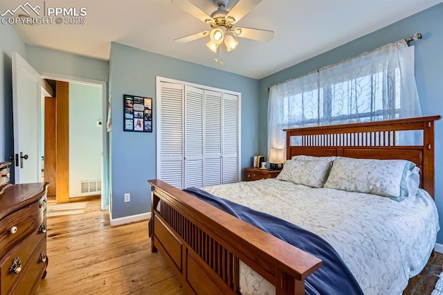 bedroom with light hardwood / wood-style floors, a closet, and ceiling fan