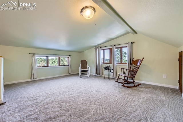 sitting room featuring vaulted ceiling with beams, plenty of natural light, and carpet flooring