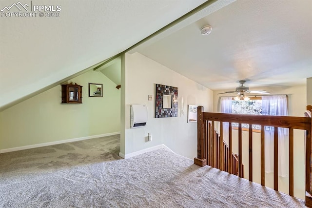 hall with vaulted ceiling and carpet