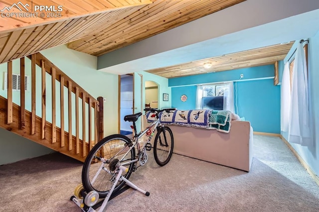 exercise area featuring wood ceiling and carpet floors