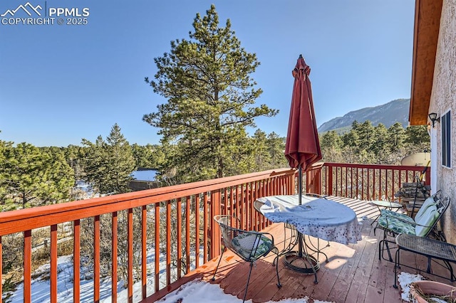 wooden deck with a mountain view