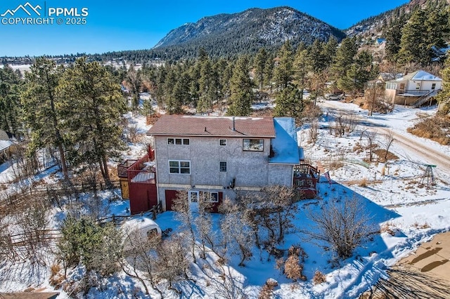 snowy aerial view featuring a mountain view