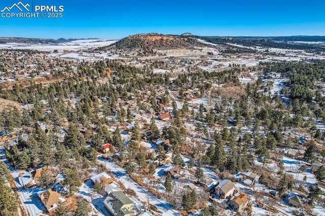 snowy aerial view with a mountain view