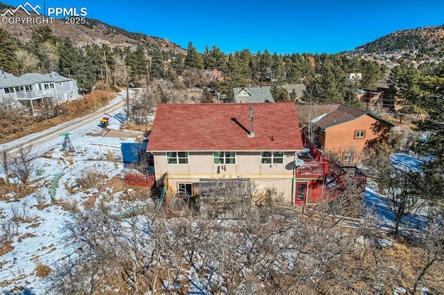 snowy aerial view featuring a mountain view