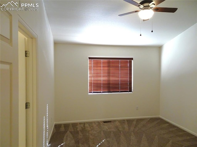 carpeted spare room with ceiling fan