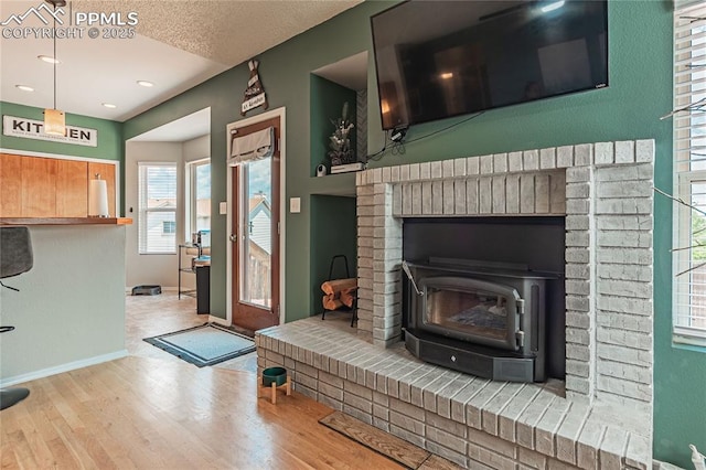 living room featuring hardwood / wood-style flooring and a wood stove