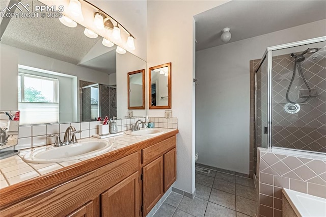 full bathroom featuring tile patterned flooring, vanity, plus walk in shower, a textured ceiling, and toilet