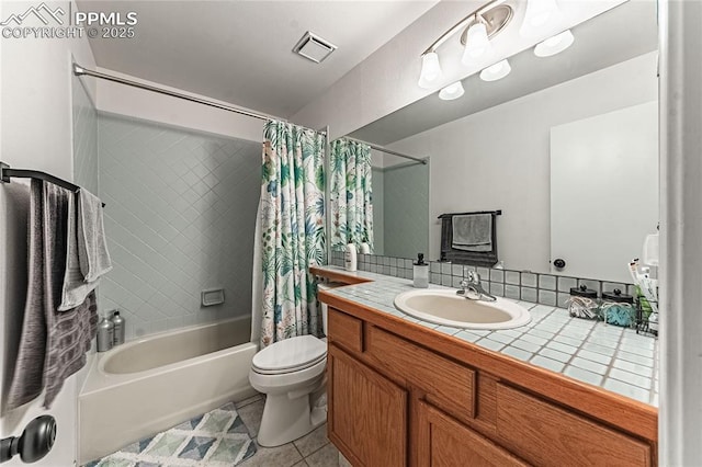 full bathroom featuring shower / bathtub combination with curtain, vanity, tile patterned floors, and toilet