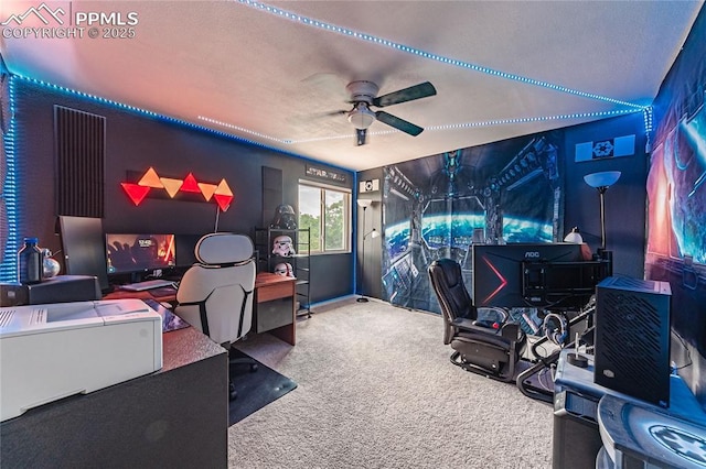 carpeted office space featuring ceiling fan