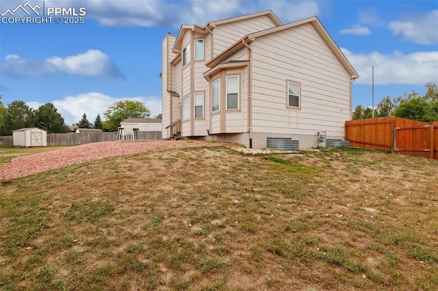 view of home's exterior featuring a yard and a storage shed