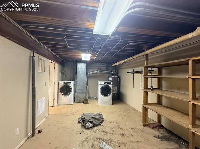 basement featuring washing machine and dryer and water heater