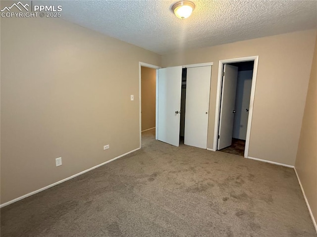 unfurnished bedroom featuring carpet floors, a textured ceiling, and a closet