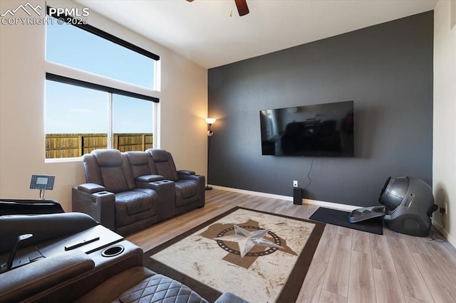 living room with hardwood / wood-style flooring and ceiling fan