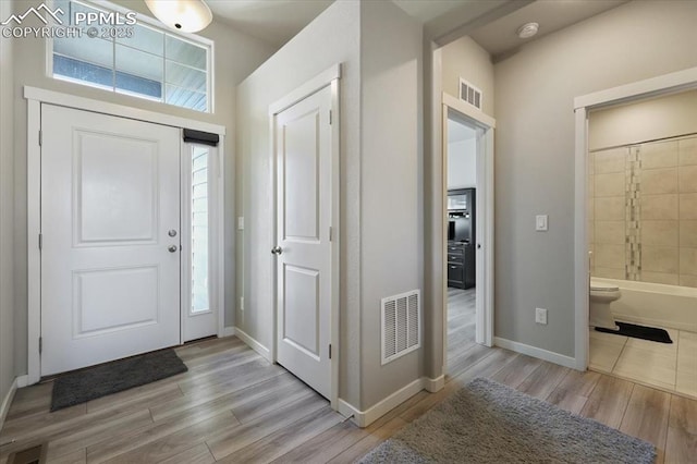 entryway with light hardwood / wood-style floors