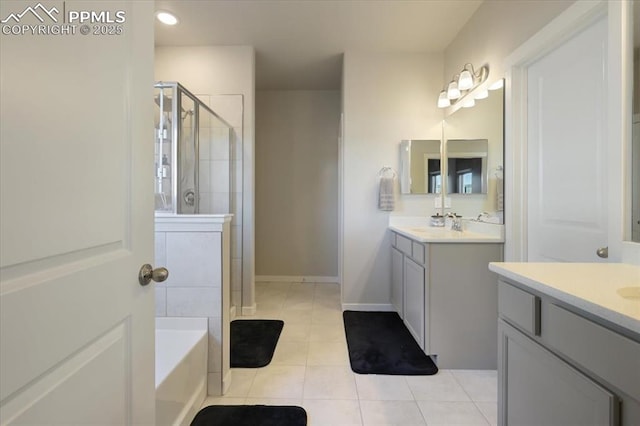 bathroom with vanity, tile patterned floors, and shower with separate bathtub