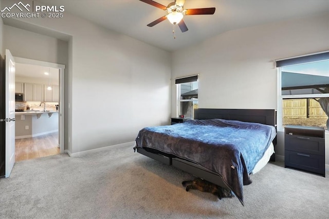 bedroom with light colored carpet and ceiling fan