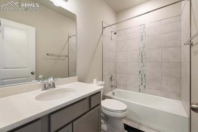 full bathroom featuring tiled shower / bath, vanity, and toilet