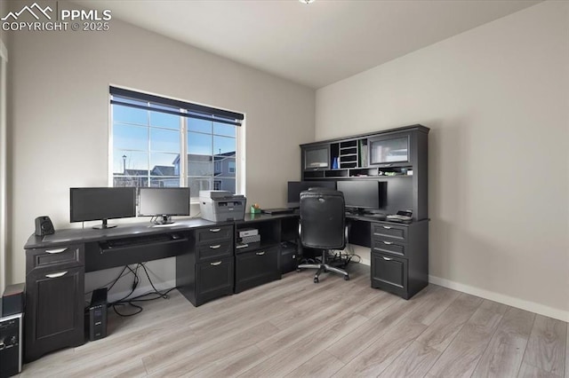 home office with light hardwood / wood-style floors