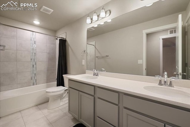 full bathroom featuring vanity, toilet, tile patterned flooring, and shower / tub combo