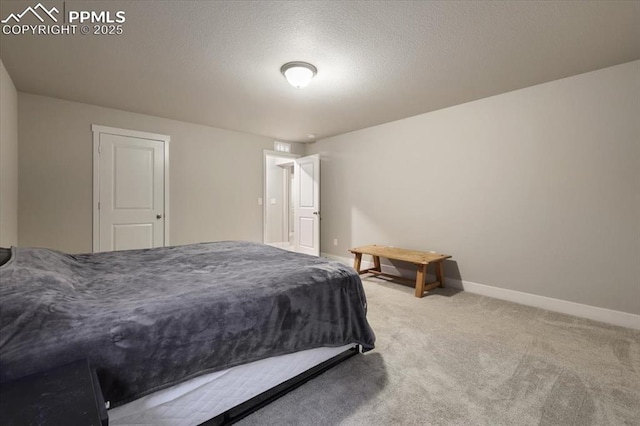 bedroom featuring a textured ceiling and carpet flooring