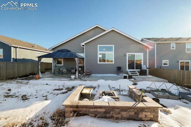 snow covered house with a gazebo