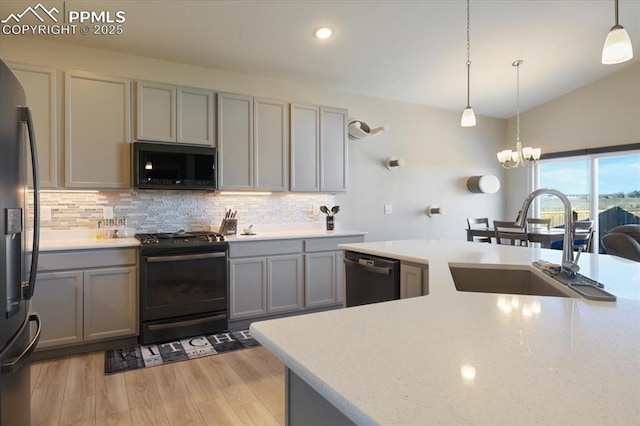 kitchen with sink, decorative light fixtures, gray cabinets, and black appliances