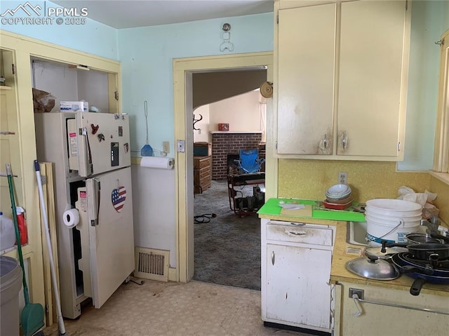 kitchen featuring white refrigerator and light colored carpet