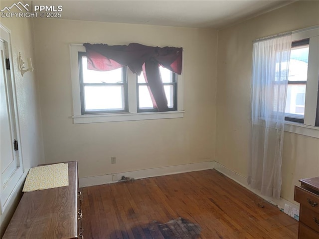 spare room with hardwood / wood-style flooring and a healthy amount of sunlight