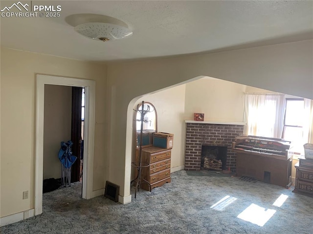 carpeted living room with lofted ceiling and a fireplace