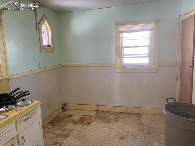 bathroom with plenty of natural light and toilet