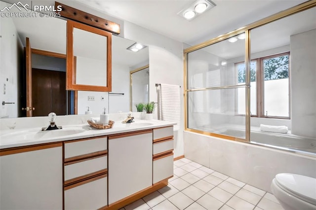 full bathroom featuring bath / shower combo with glass door, vanity, tile patterned floors, and toilet