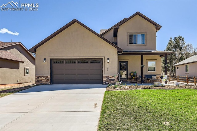 view of front of home featuring a garage, a front lawn, and a porch