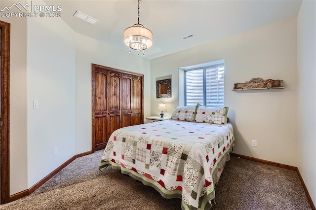 bedroom with a closet and dark colored carpet