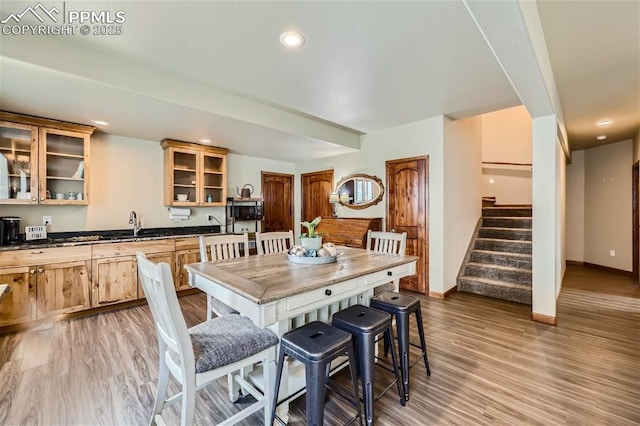 dining area featuring sink and light hardwood / wood-style floors