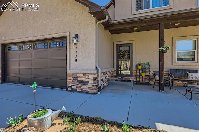 property entrance with a garage and a patio