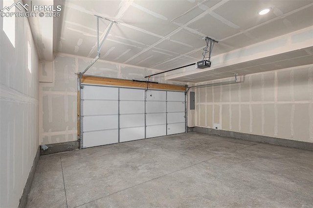 garage with a garage door opener and electric panel