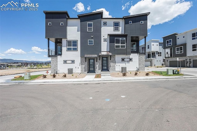 view of front of house with a mountain view and cooling unit