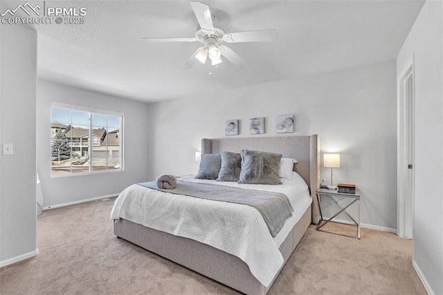 bedroom with light colored carpet and ceiling fan