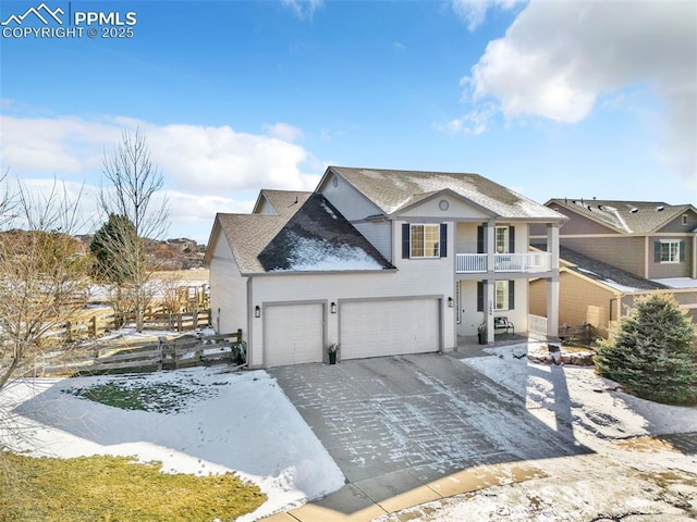 view of front of home featuring a garage and a balcony