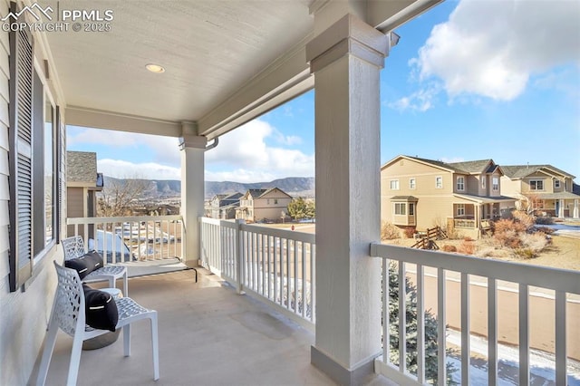 balcony featuring a porch and a mountain view