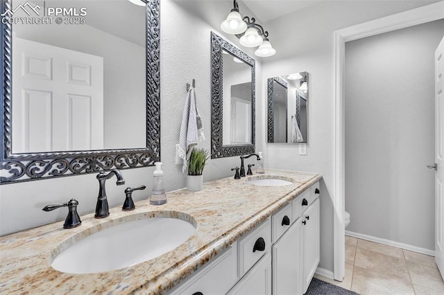 bathroom featuring vanity, tile patterned flooring, and toilet