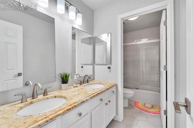 full bathroom featuring tile patterned flooring, vanity, shower / bath combination with glass door, and toilet