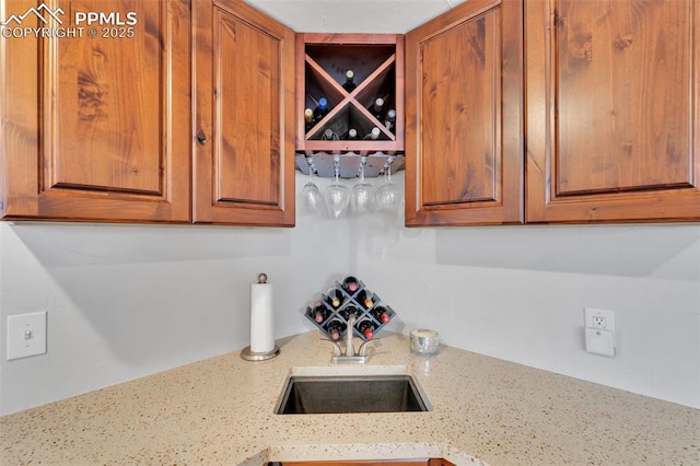 kitchen featuring light stone countertops and sink