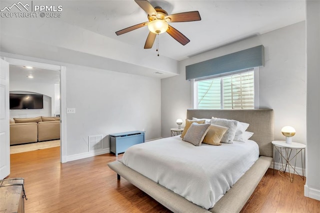 bedroom with hardwood / wood-style floors and ceiling fan