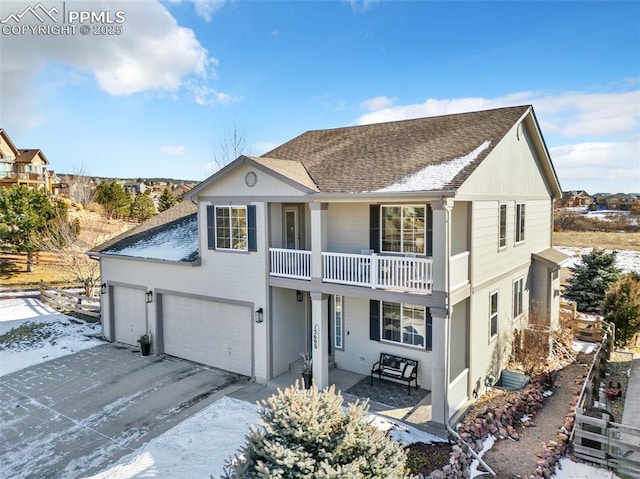 view of front of home featuring a garage and a balcony